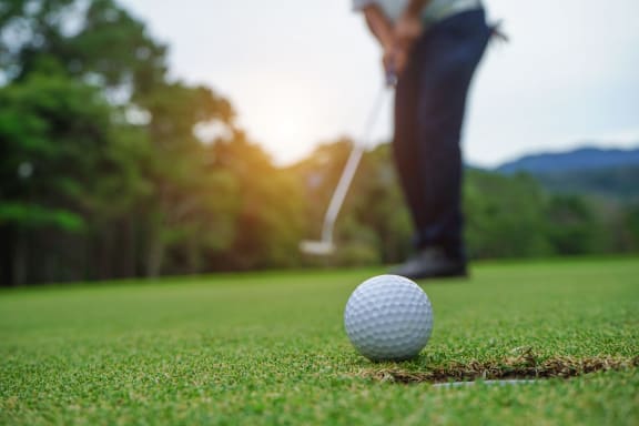 a golfer teeing off at a golf course at 2929 on Mayfair, Wauwatosa