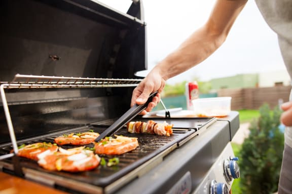 a man grilling food on a bbq at 2929 on Mayfair, Wisconsin