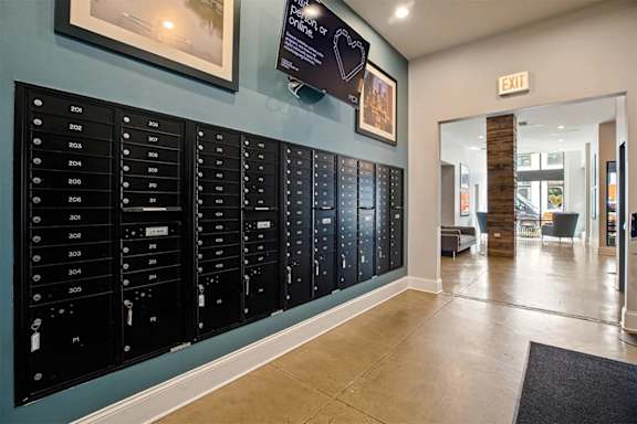 A wall of mailboxes in a hallway.