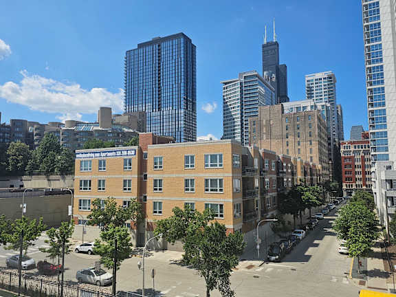 A city street with apartment buildings and cars.