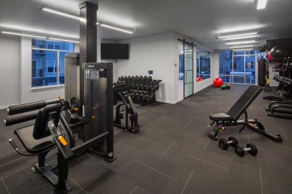 a gym with cardio equipment and weights in a building at 2929 on Mayfair, Wisconsin