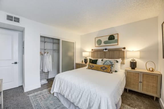 master bedroom in fusion Warner center 2-bedroom apartment in Woodland Hills, CA with large bed and plush carpet.