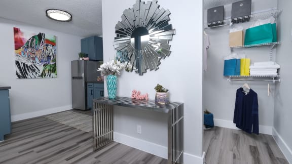 foyer in fusion one bedroom apartment in Las Vegas with modern console table and wood-style plank flooring