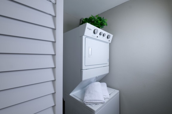 Stacked laundry in Mandarin bay 1-bedroom apartment with washer and dryer hookups in-unit.