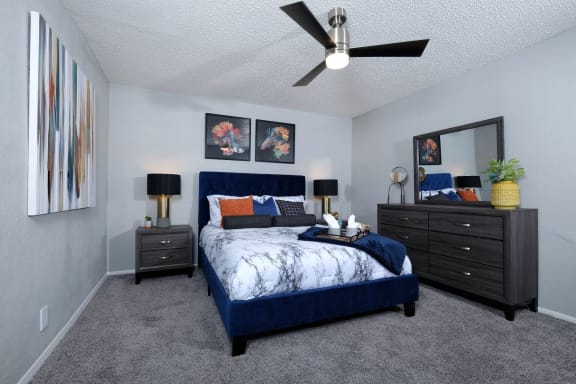 Master in Stadium 700 3-bedroom apartment in Arlington with ceiling fan and plush carpet.