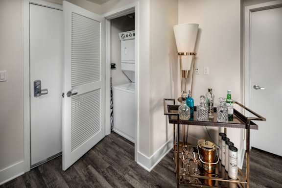 A white door with a glass window is open to a kitchen.