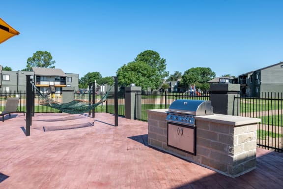 Grilling station and hammock lounge at fusion Fort Worth apartments in Haltom City, Texas