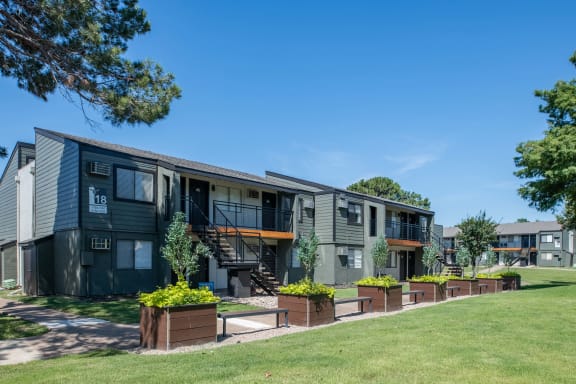exterior shot of fusion fort worth apartment complex in haltom city, Texas with large planter boxes and green lawn