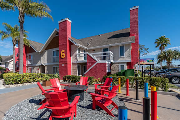 A red and white building with a number 6 on it at Fusion Orlando Apartments.
