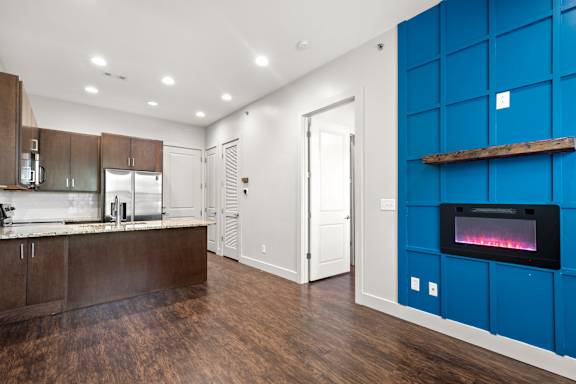 A modern kitchen with a wood and white color scheme.