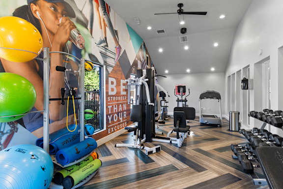 Fusion Orlando fitness center with a variety of equipment including weights and exercise balls.
