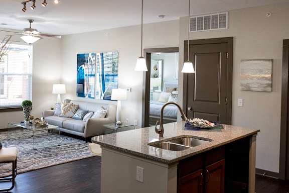 A modern kitchen with a large island and a dining area.