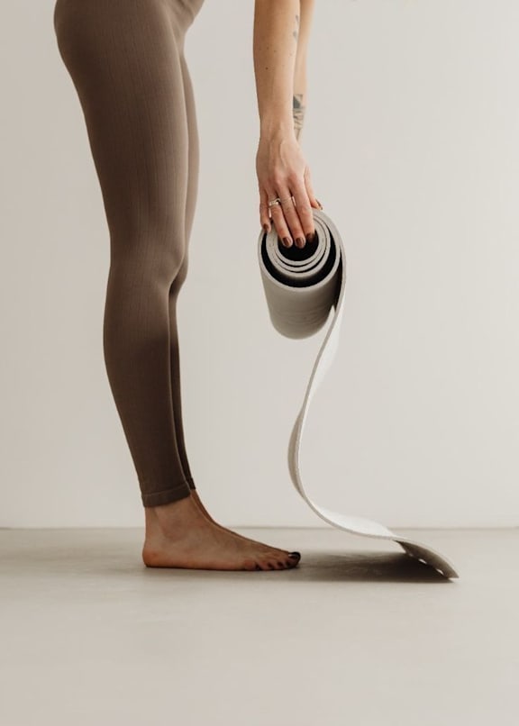 A person is holding a grey and white object.