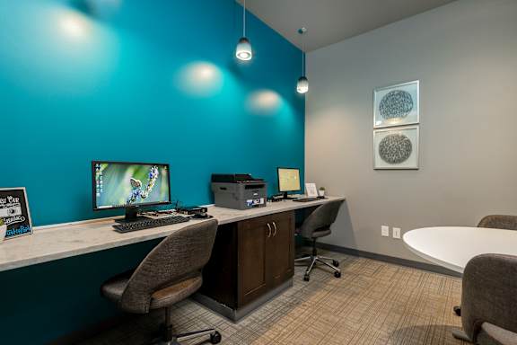 A room with a blue wall and a computer on it.