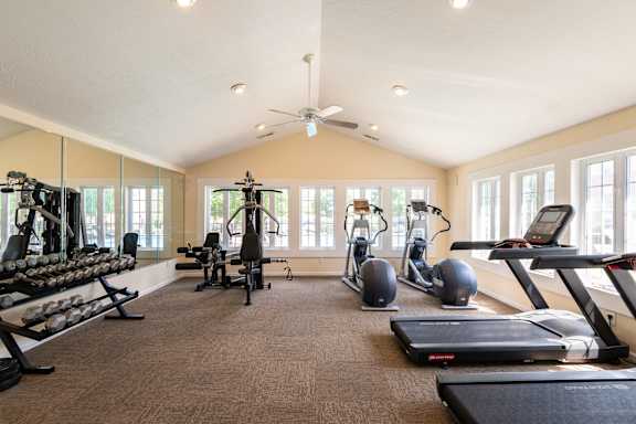 A spacious home gym with a variety of exercise equipment.