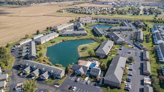 an aerial view of the campus of the university of alberta with a pond in the