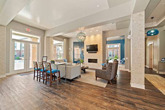 A spacious living room with a fireplace and a television.