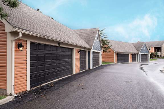 A row of houses with garages on the side.