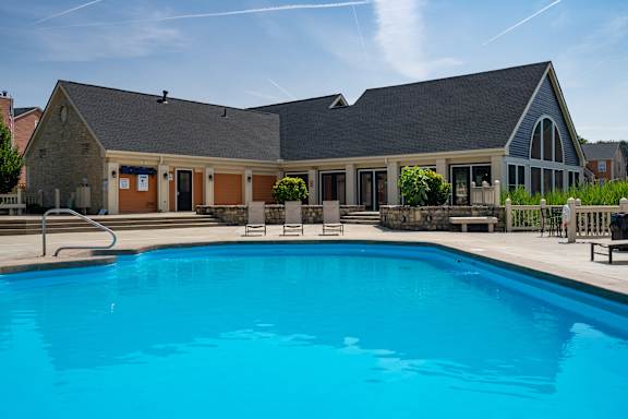 A large swimming pool in front of a building.