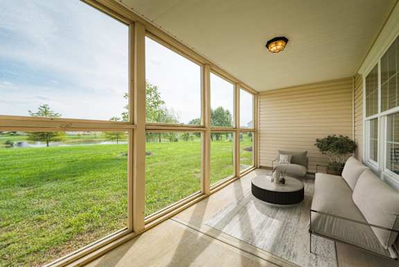 A sunny day in a room with a couch and a table.