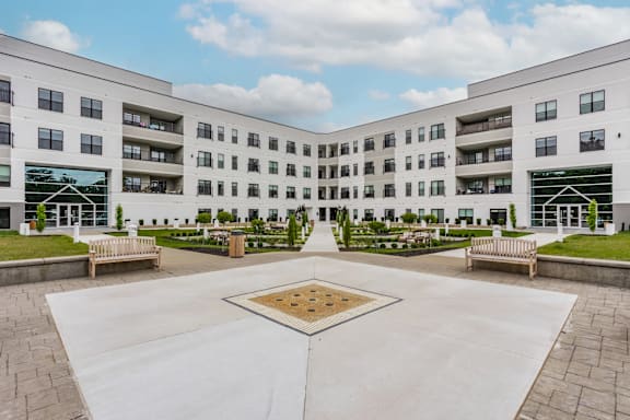 A courtyard with a square in the middle surrounded by apartment buildings.