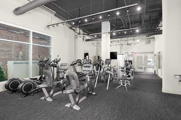 A gym with a variety of exercise equipment.