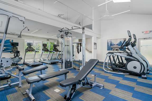 A gym with a variety of equipment including a leg press machine.