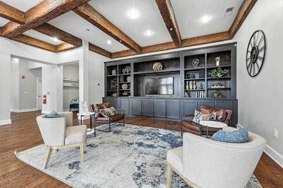 A living room with a white couch and a wooden ceiling.
