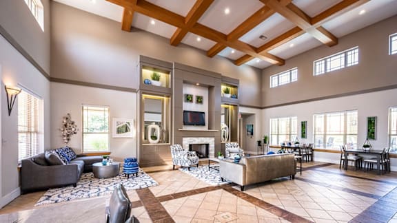 A spacious living room with a fireplace and a large couch.