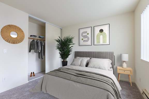 A bedroom with a large bed and a plant at Cherrywood Apartments, San Jose, 95118