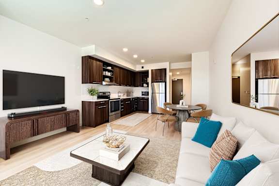 A modern living room with a white couch and a coffee table.
