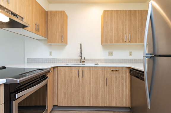 A kitchen with wooden cabinets and stainless steel appliances.