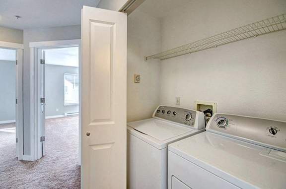 an empty laundry room with a washer and dryer
