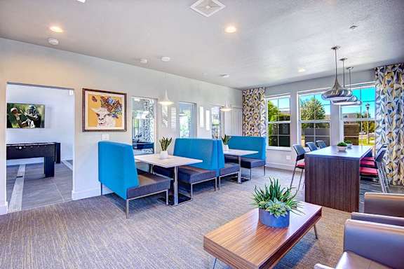 the dining room of a restaurant with blue chairs and tables