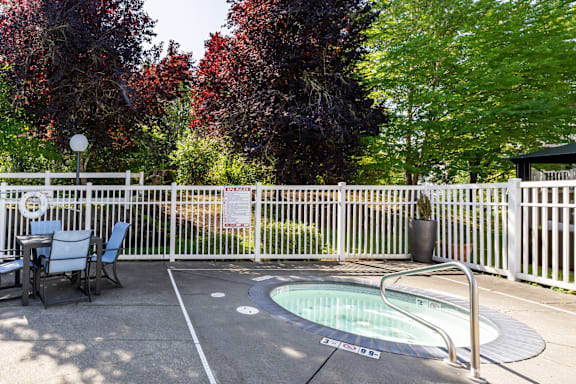 A small pool surrounded by a white fence.
