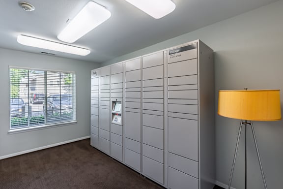 A room with a large grey filing cabinet and a yellow floor lamp.