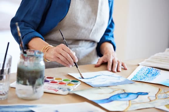 A person is painting a picture with watercolors.