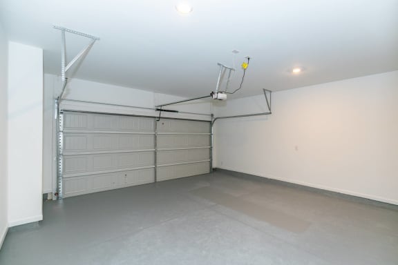 a garage with a white wall and a white garage door