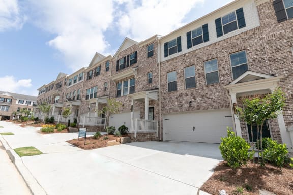 an apartment building with a garage door in front of it