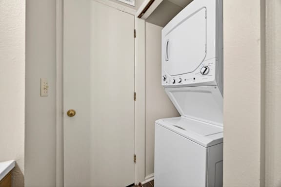 A white dryer is in a small room.