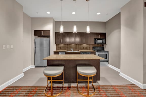A kitchen with a bar stool and a counter.