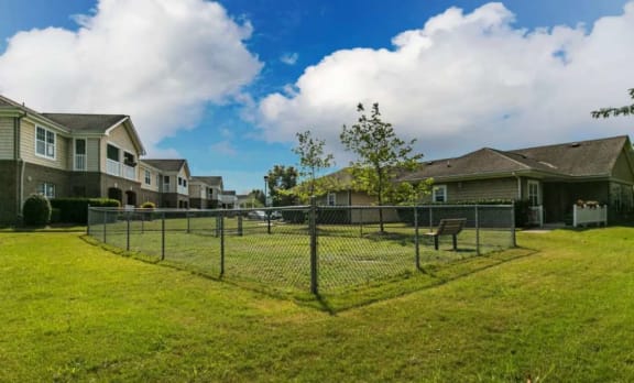 a fenced in yard with houses in the background