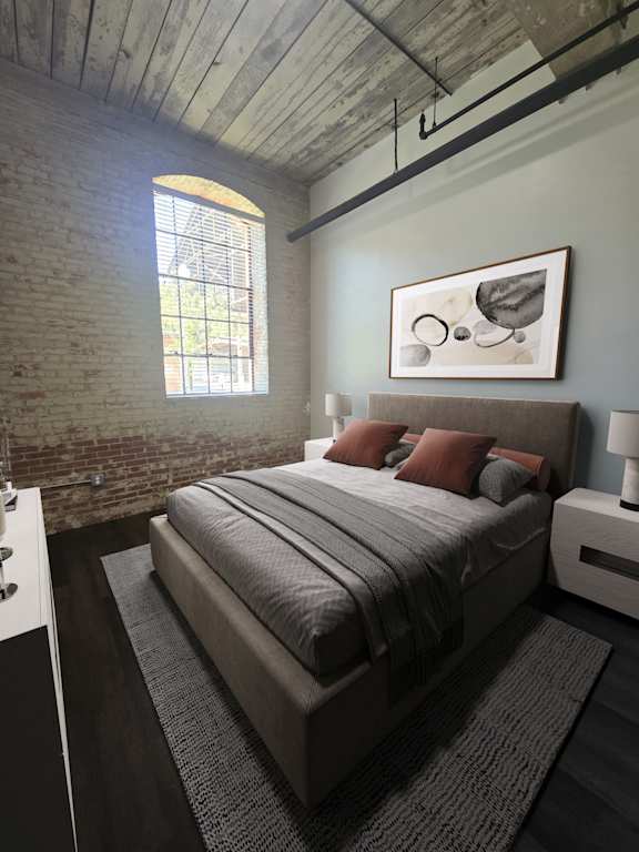 A bedroom with a bed, nightstand, and a window with a view of a fence and trees.