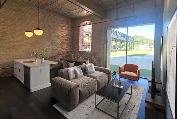 A modern living room with a brick wall and a large window.