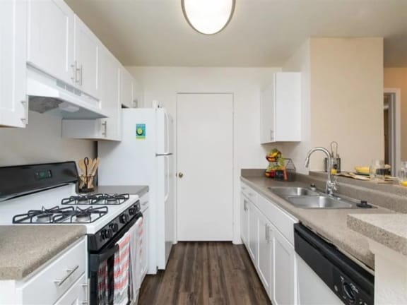 a kitchen with a stove top oven next to a sink