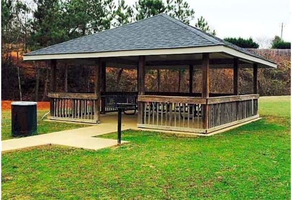 a gazebo in the middle of a grassy field