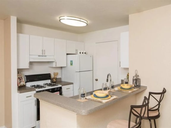 a kitchen with a counter top and a stove top oven