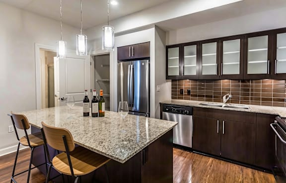 A kitchen with a granite countertop and modern appliances.