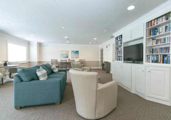 a living room filled with furniture and a flat screen tv
