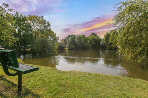 a park bench sitting next to a body of water